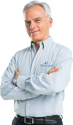 mature businessman standing confidently with arms crossed